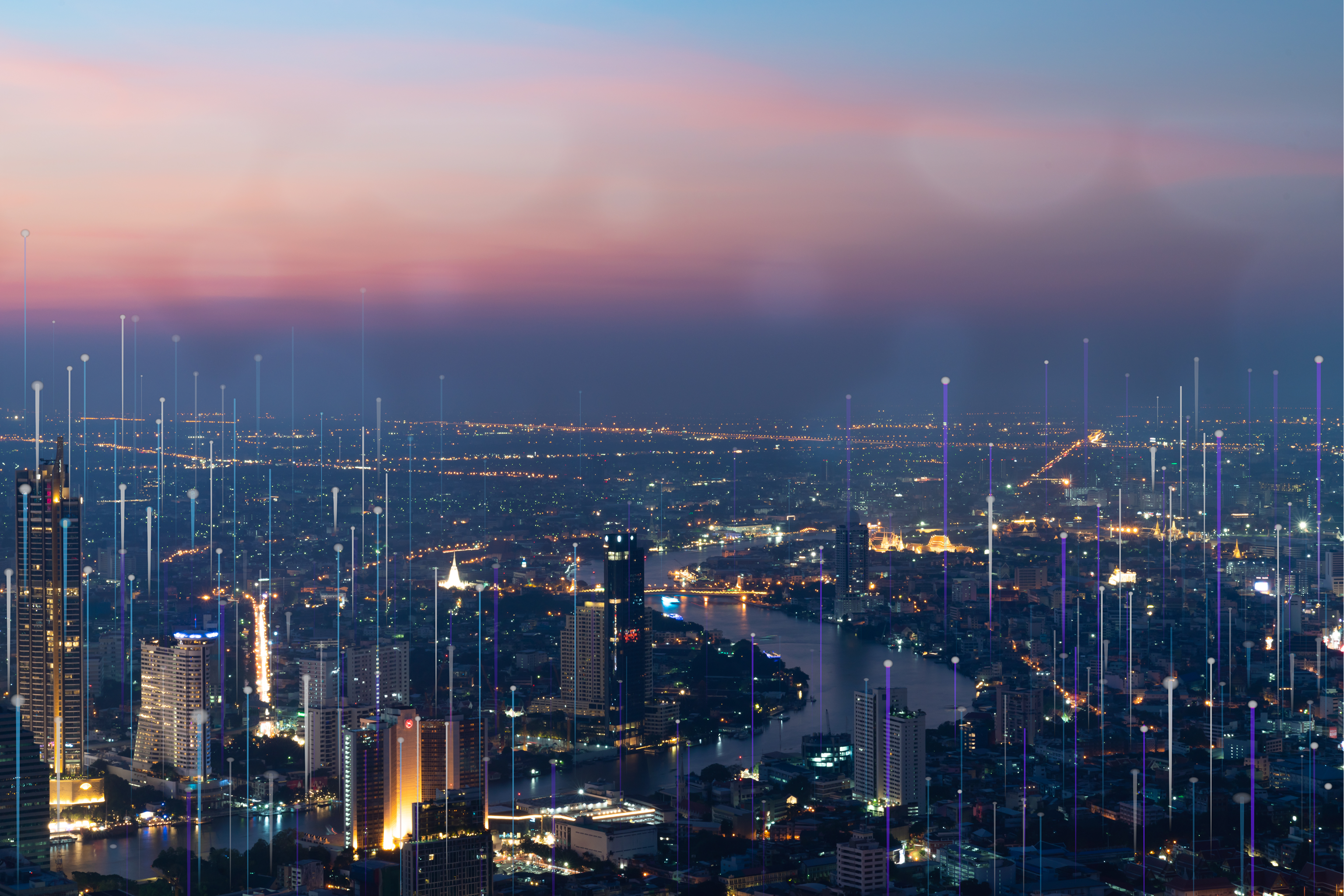 Smart city skyline at dusk with glowing digital network connections.